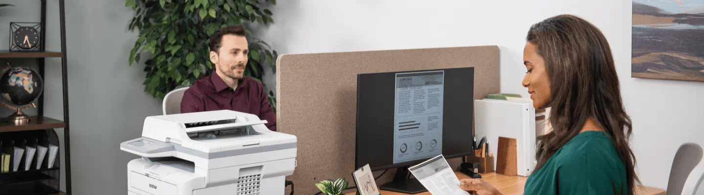 Person at work with a brother printer in front of them